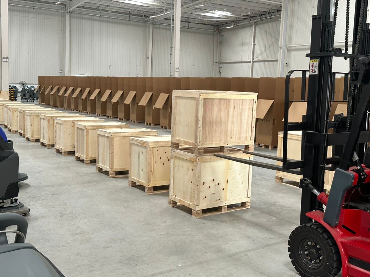 Alton T2 floor scrubbers packed in wooden crates loaded by forklift